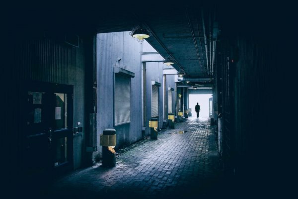 Man walking down alley