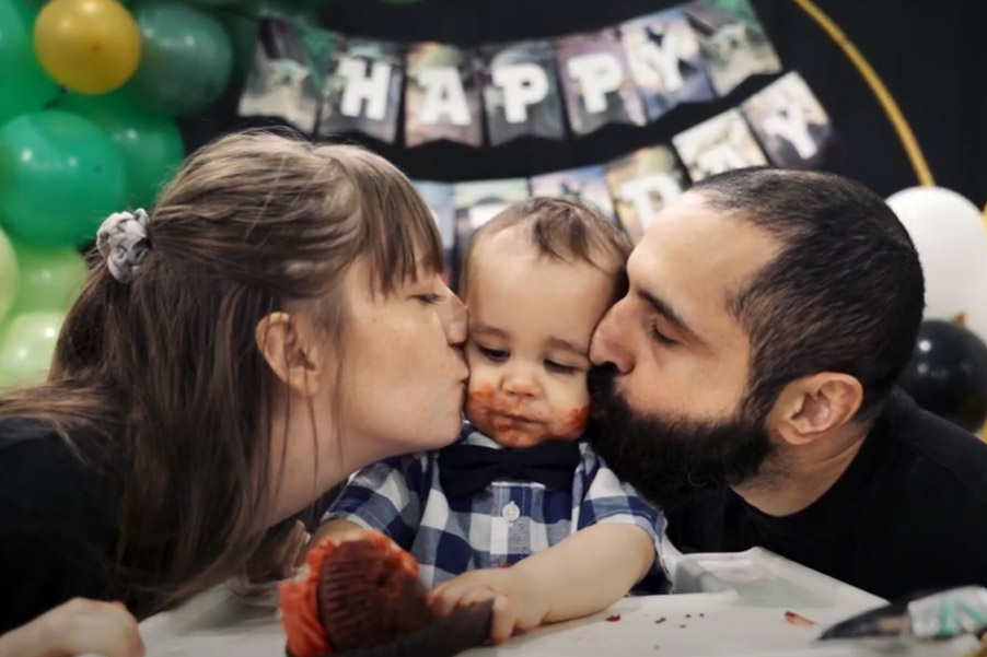 Boy being kissed by parents