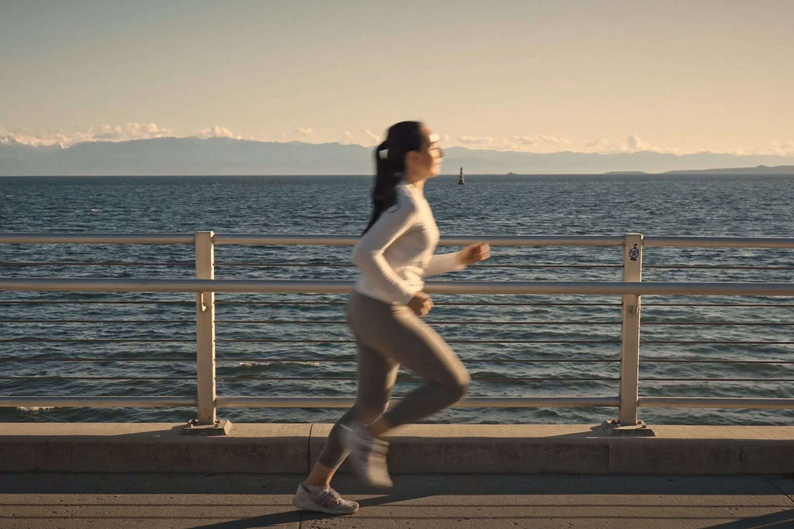 A young lady runs along the ocean